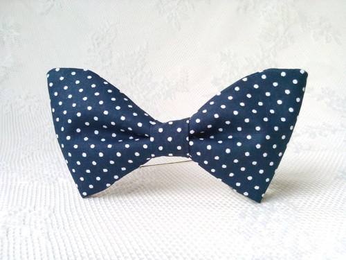 Dark navy blue bow tie with small white polka dots