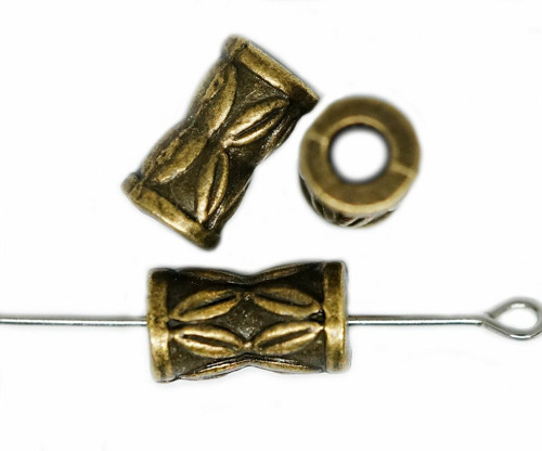 Styl kovový korálek, zdobený, rozměry 11 mm x 6